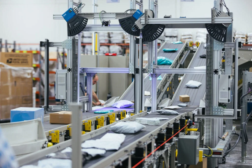 Automated barcode scanner and data capture station above a conveyor