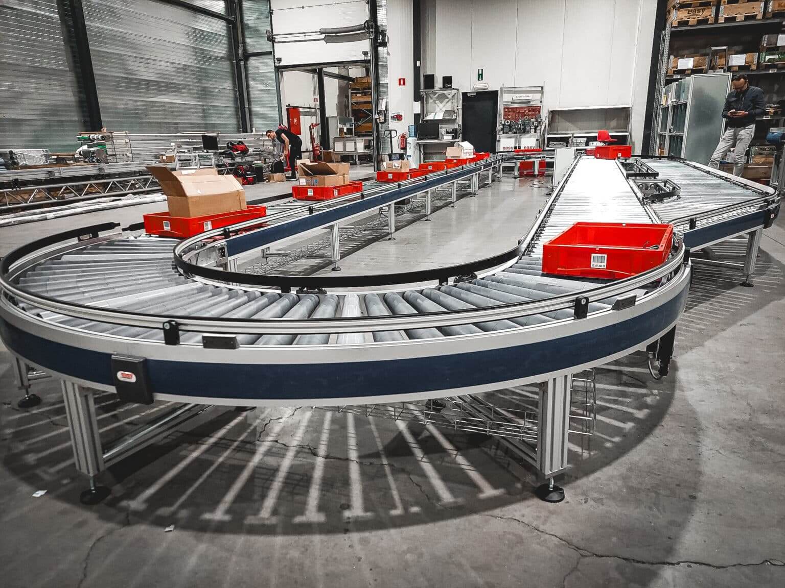 Roller conveyors moving cartons through an e-commerce warehouse